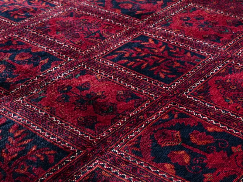 close up of red wool fibres in carpet